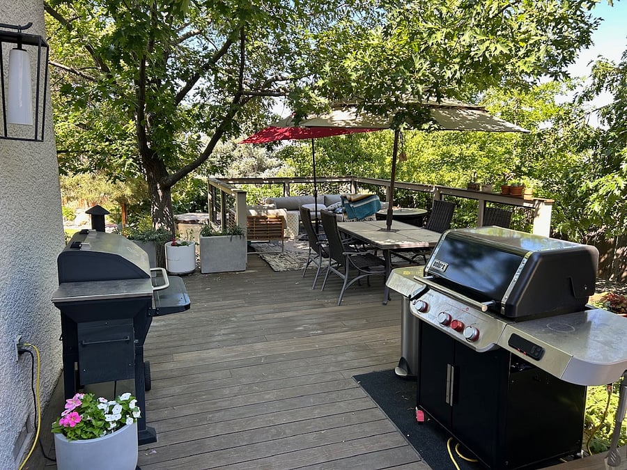 Backyard deck with BBQ and smoker. Comfortable outdoor seating and dinning plus gas fireplace.