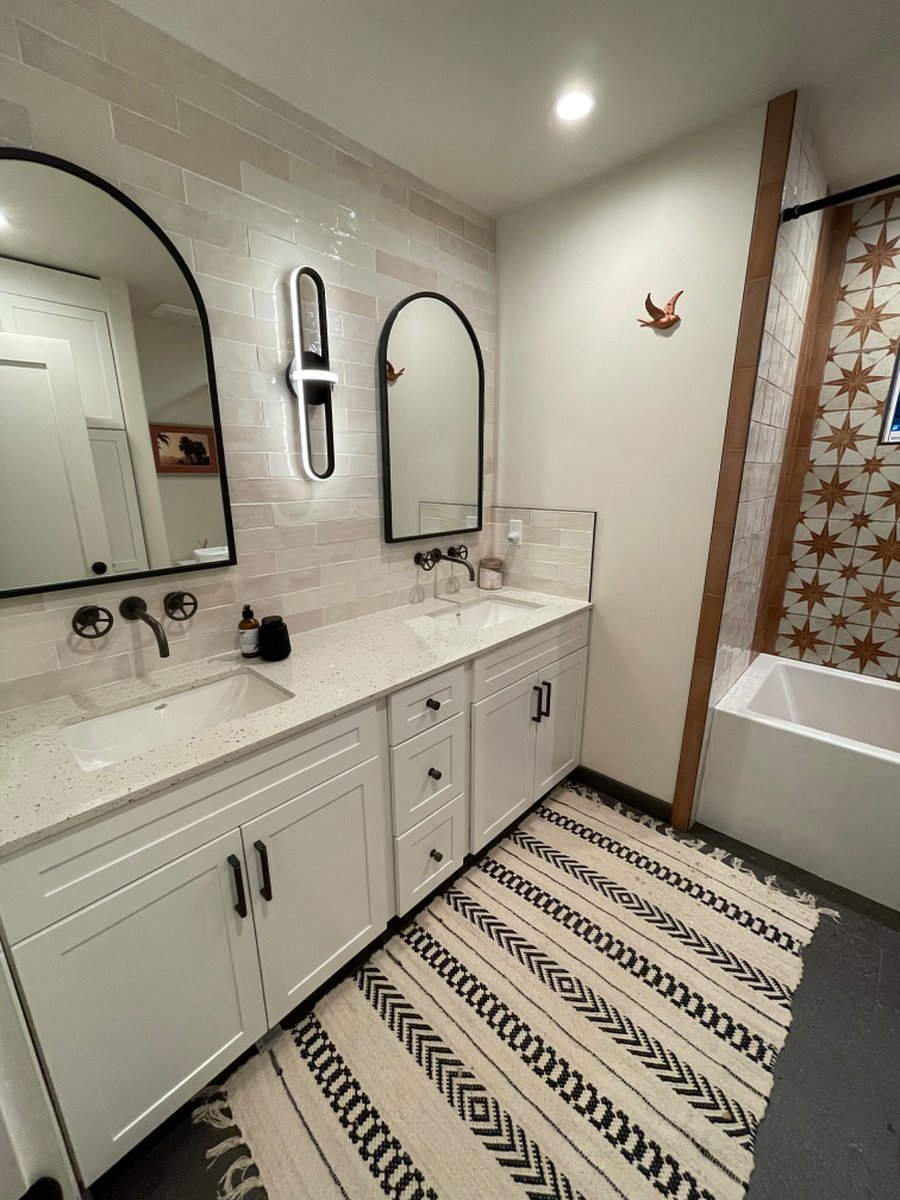 Beautiful guest bath with full size soaking tub and shower plus dual sinks.