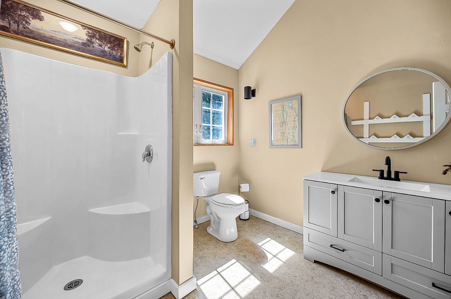 Spacious bathroom 1 w/ toiletries and cleaning supplies