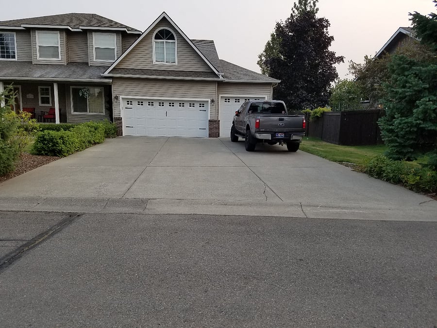 Oversized parking behind a three-car garage.