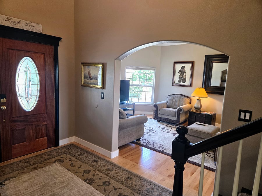 A view into the living room where there is a TV and separate area to unwind.