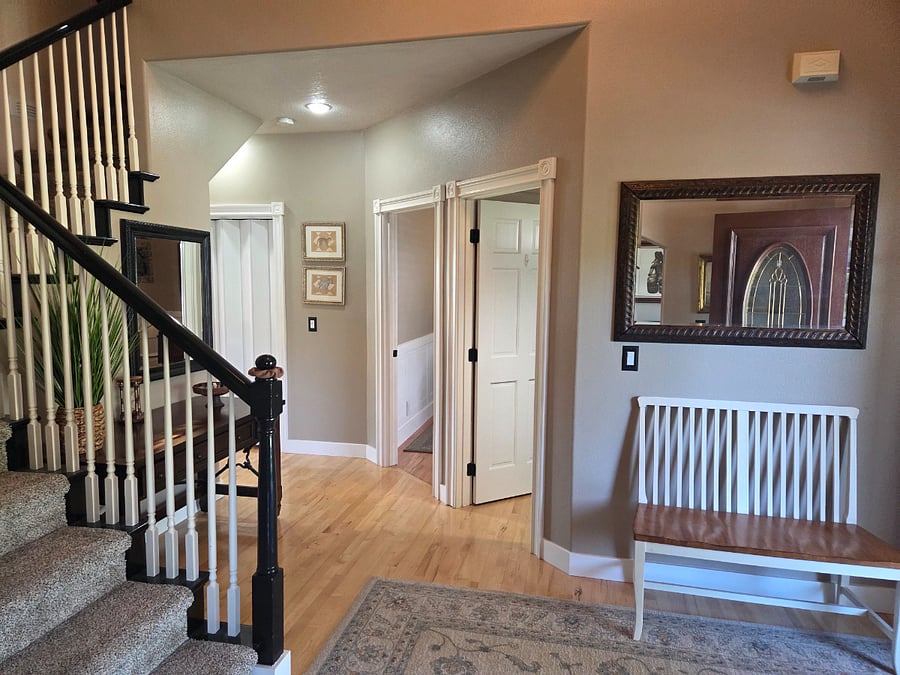 A view into the open concept family room and kitchen. A well-equipped and spacious office is just to the right of entry.