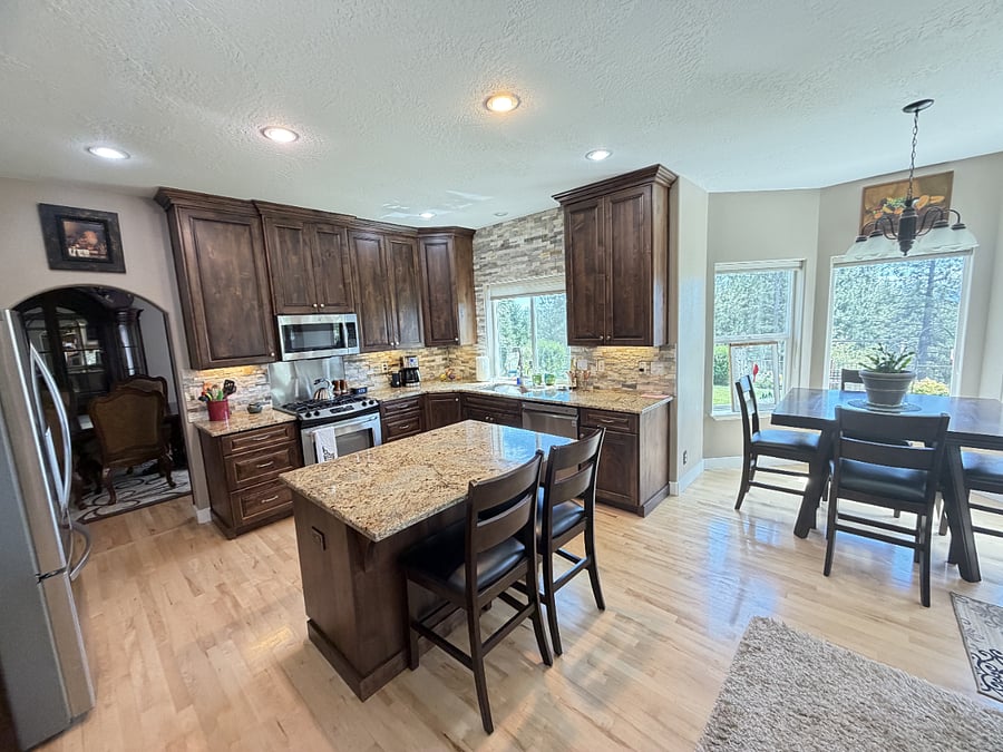 Well-appointed kitchen with granite counters and stainless steel appliances. An elegant gathering place.