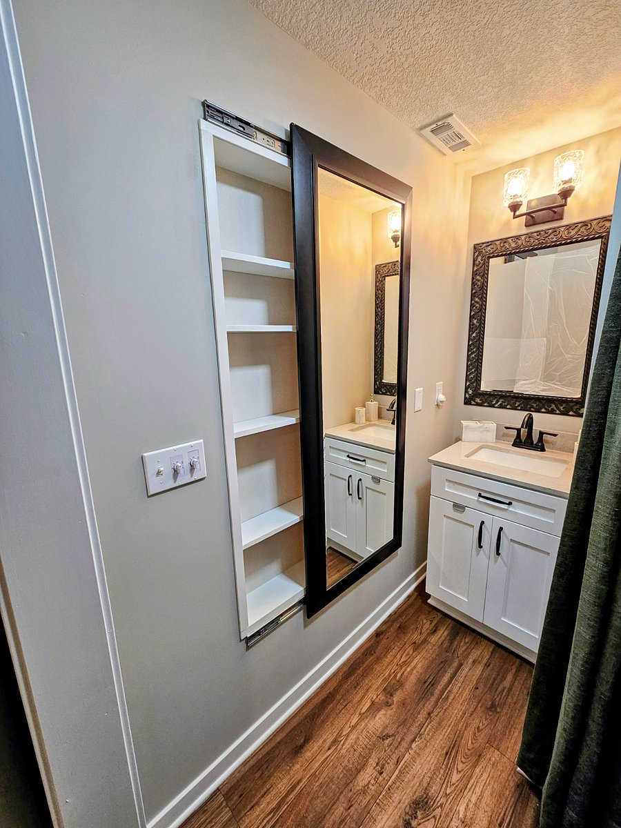 Convenient hidden bathroom storage keeps personal items organized and out of sight.