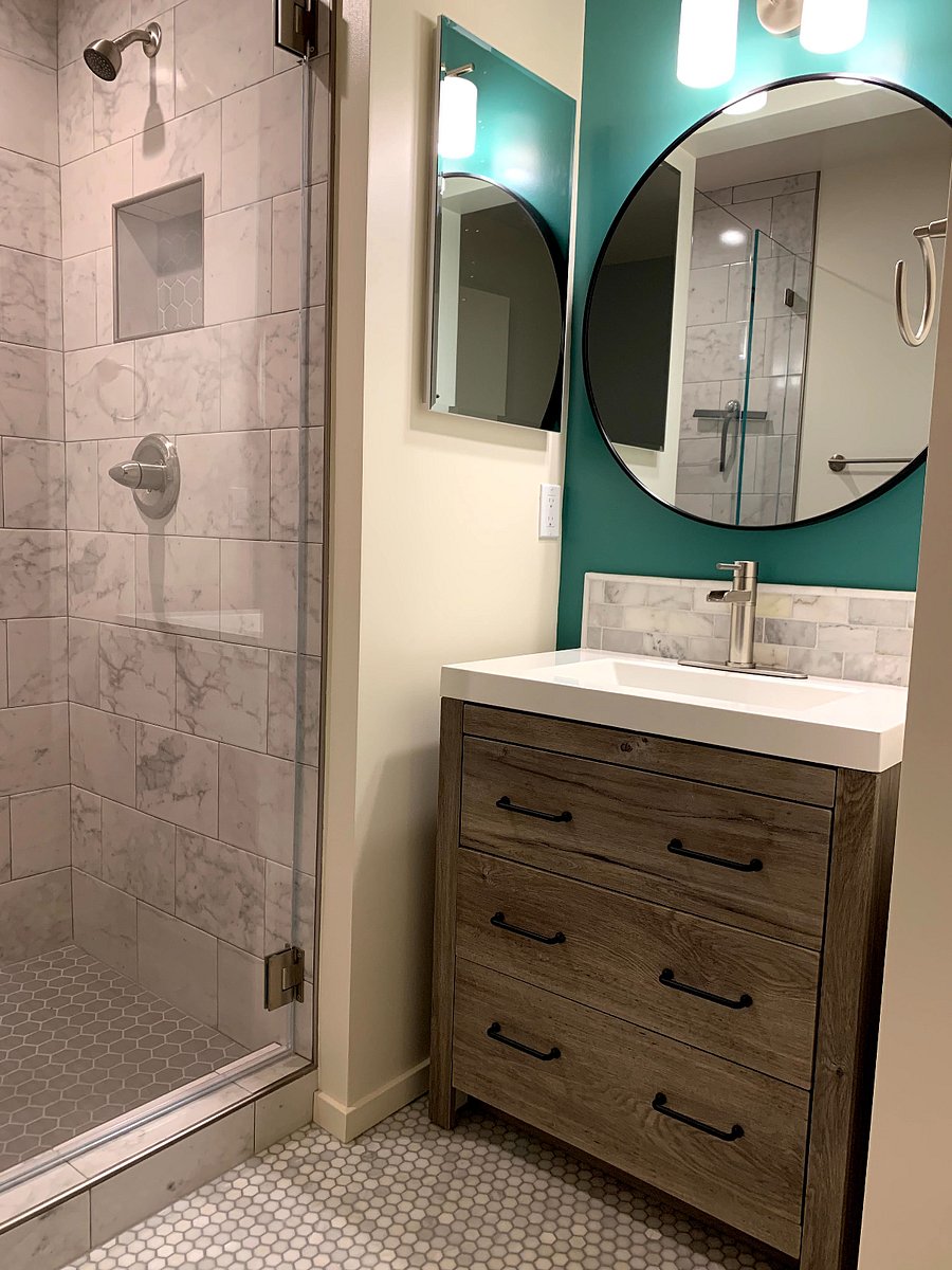 Shower and bathroom vanity. Medicine cabinet opens up to storage.