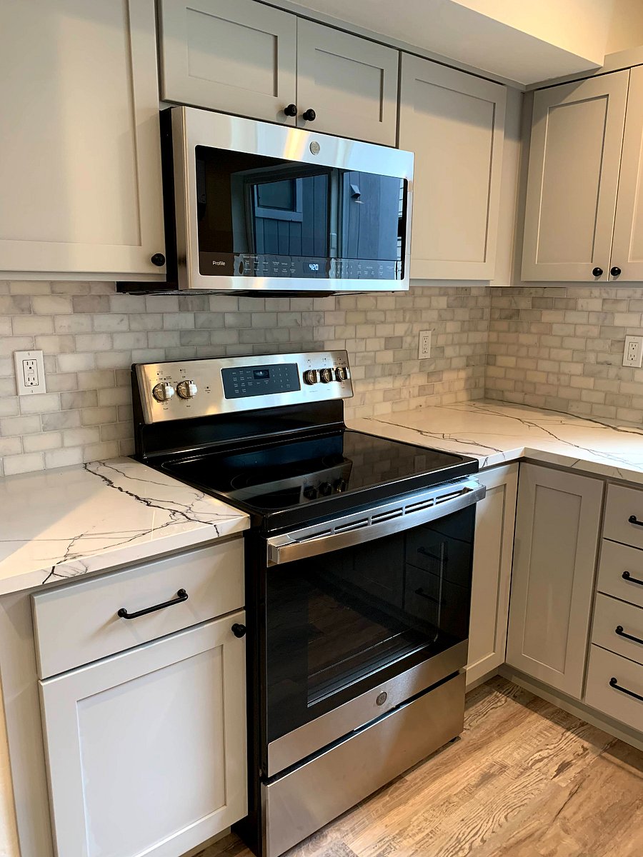 New oven, stove and microwave, marble backsplash and stone countertops