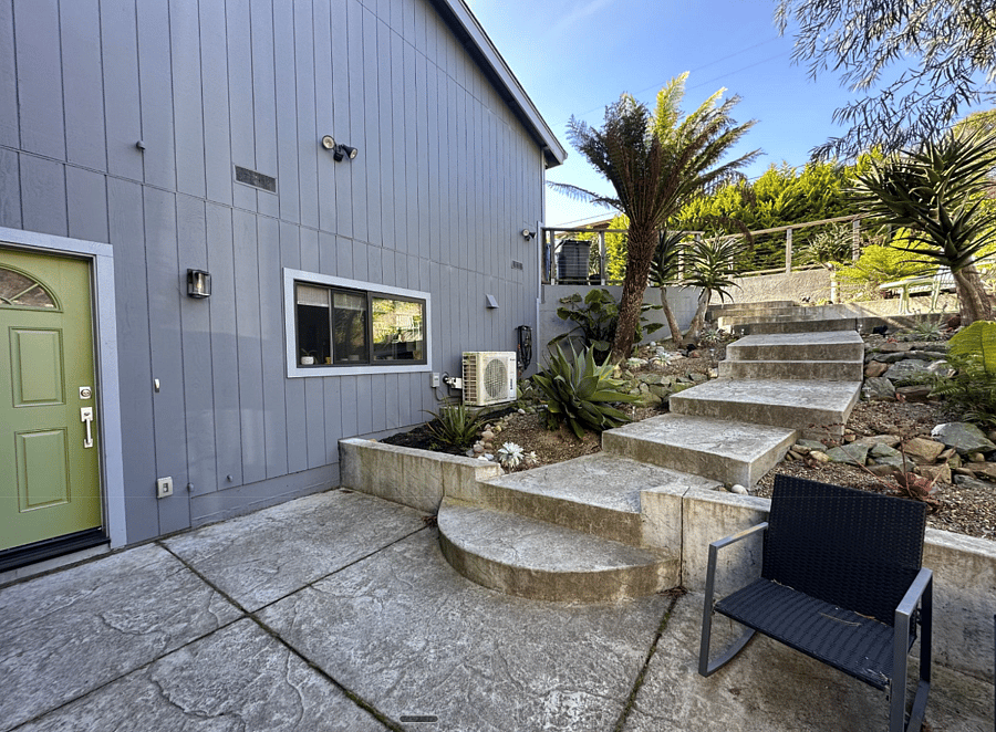 Patio landing, front door, kitchen window. Parking spot at top of stairs (street level)