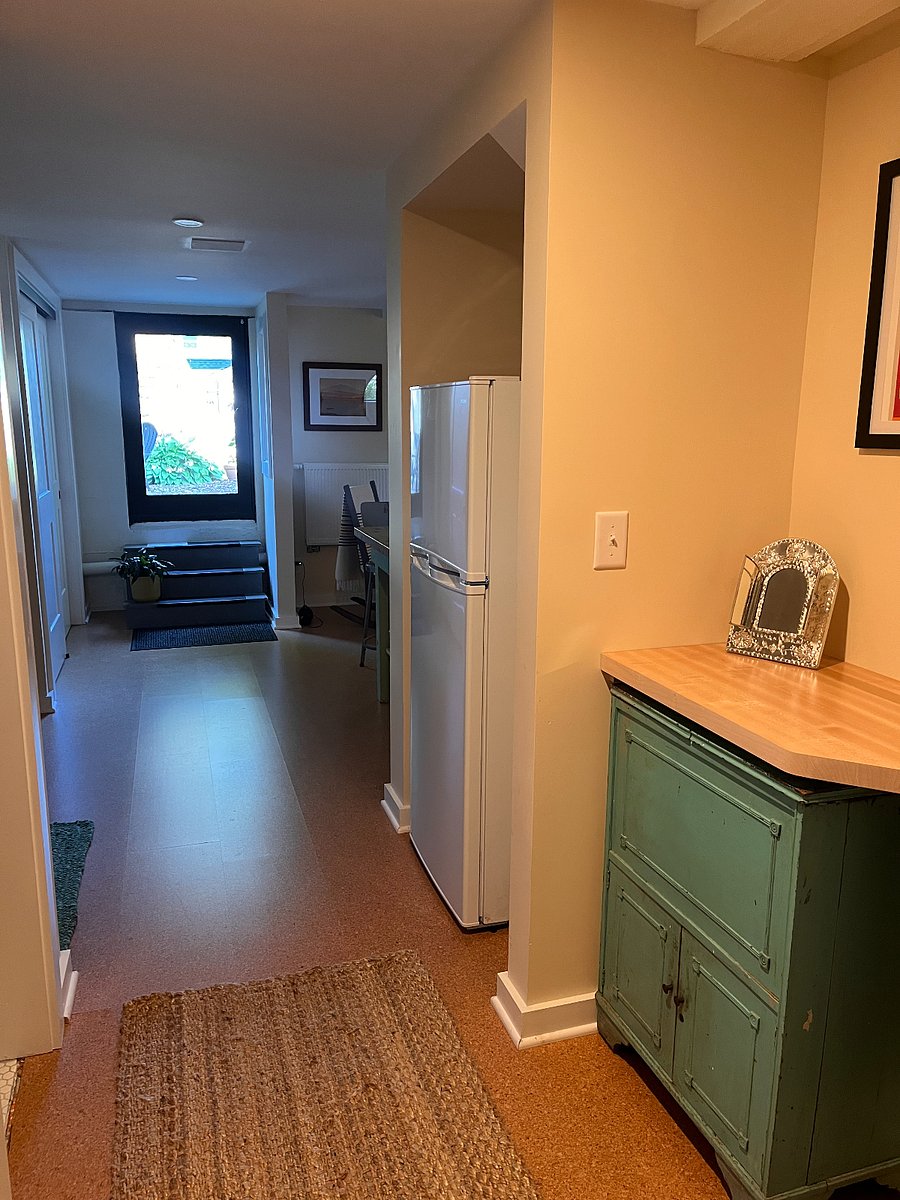Hallway from bedroom to kitchen area, bathroom on left.