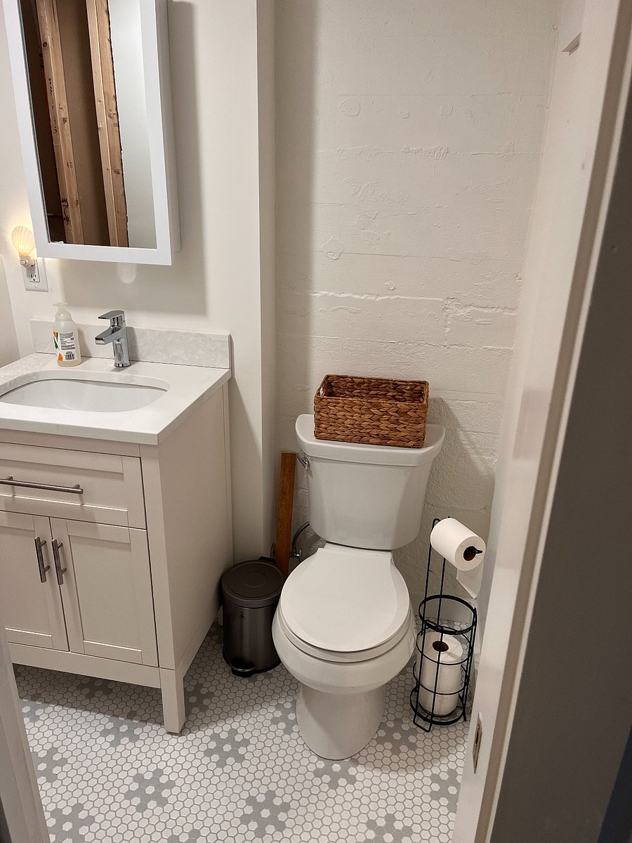 Full bathroom with newly tiled shower.