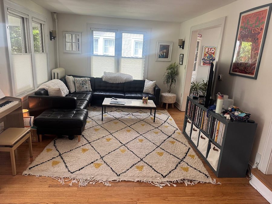 Living room on first floor with smart TV, record player, ample seating.