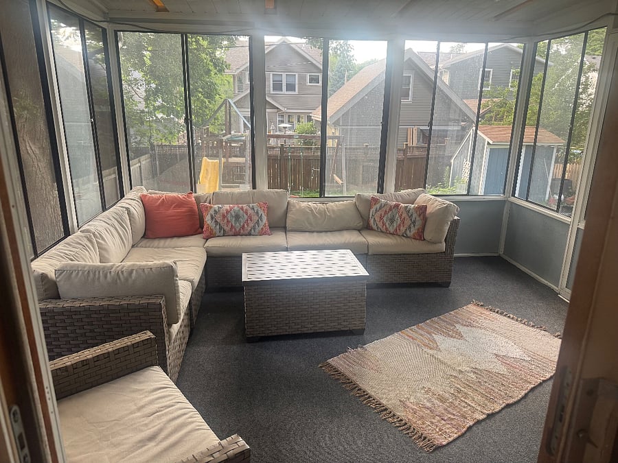 Lovely screened-in porch overlooks large fenced-in backyard.