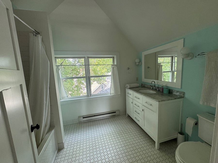 Primary bathroom on third floor with bathtub and shower.