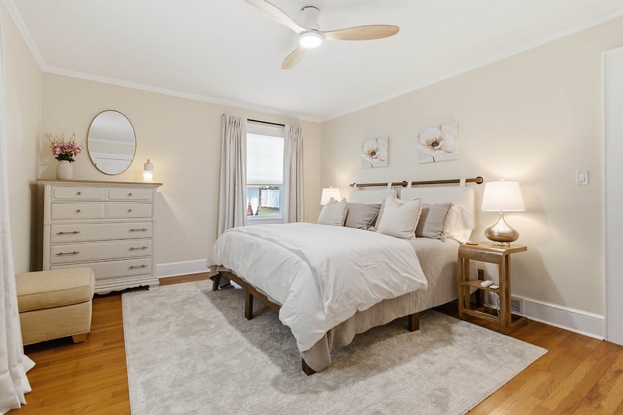 Primary bedroom 1 with king bed, closet, dresser, full length mirror, premium bedding, blackout curtains.