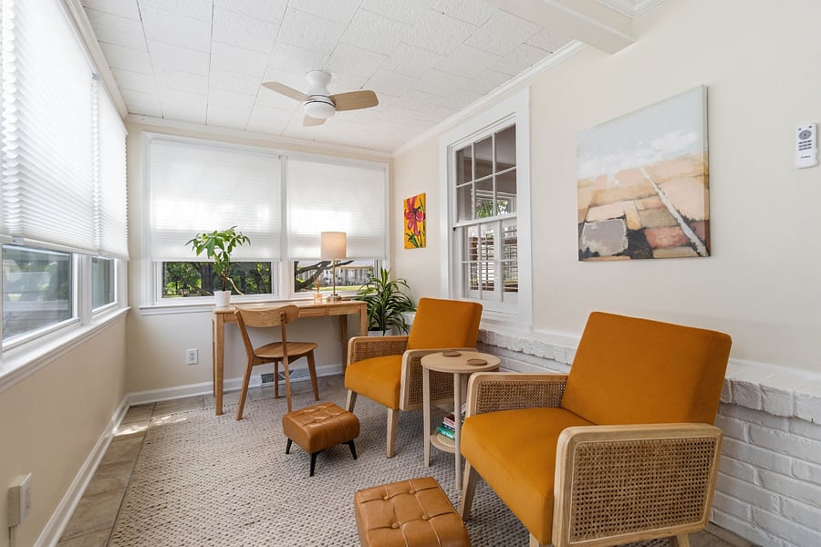 Sunroom with dedicated workspace.
