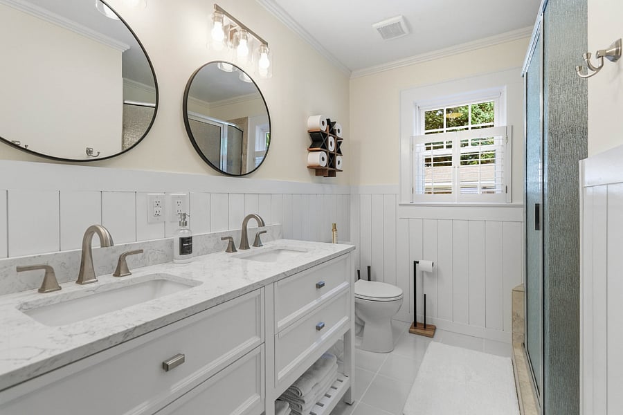 Double vanity, shower, towels, hair towels, two hair dryers, curling iron, and straightening iron.