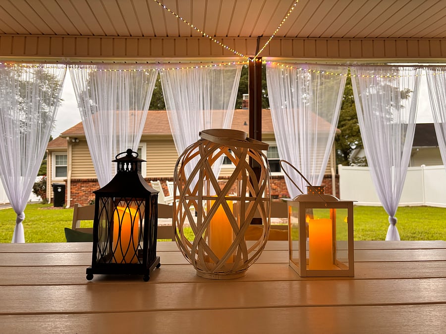 The backyard is designed as an extension of the homes living space, offering a covered alfresco dining area. A mounted outdoor TV adds an extra layer of comfort and entertainment.