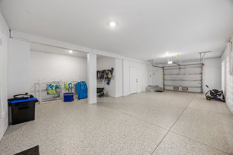 2 car tandem garage with extra storage area, beach chairs, drying racks, hose, ice chest with wheels, wagon. 