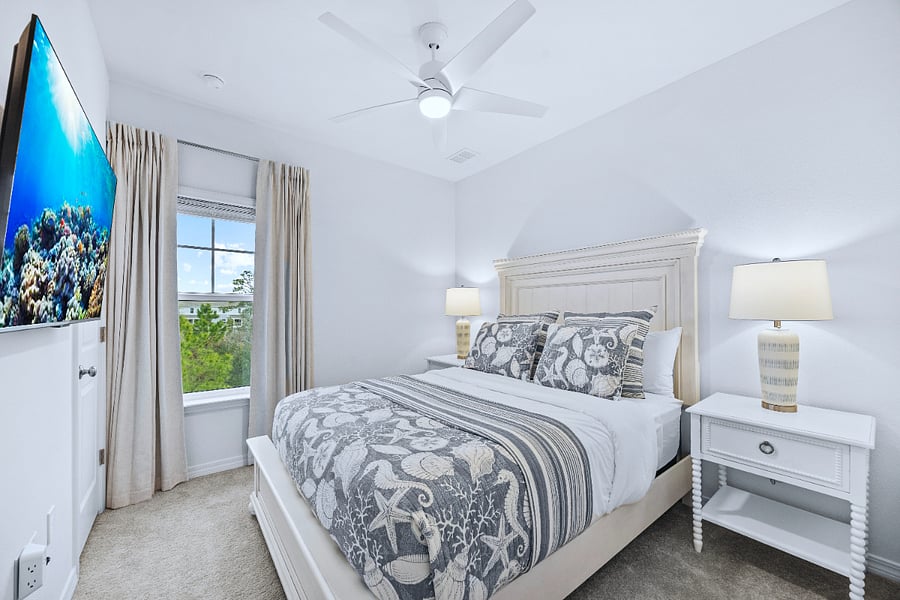 Queen bedroom with smart tv, closet, black out curtains, premium hybrid mattress, cotton bedding, closet, ceiling fan, noise-maker, and night stands. Nature preserve views. 