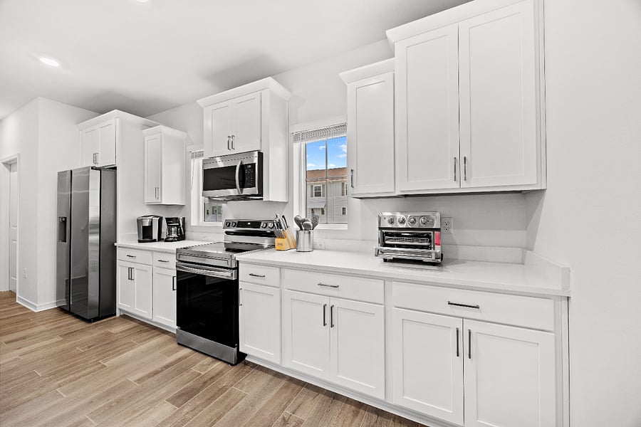 Sparkling clean kitchen with electric range, microwave, toaster oven/air fryer, blender, crock pots, fridge, mixer, drip coffee maker, kcup coffee maker, etc. 