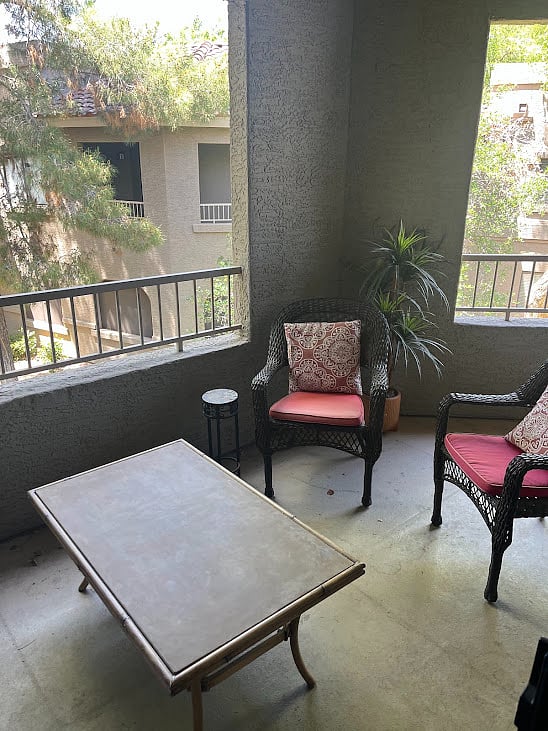 Smaller covered patio with cozy space for coffee.