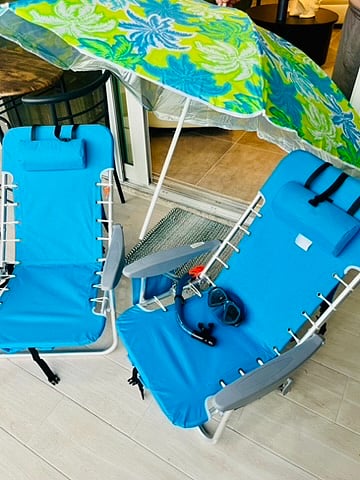 Two backpack style beach chairs with snorkels and goggles and umbrella for bike trips to the beach!  Beach towels, hats, and drying hooks protect and finish.