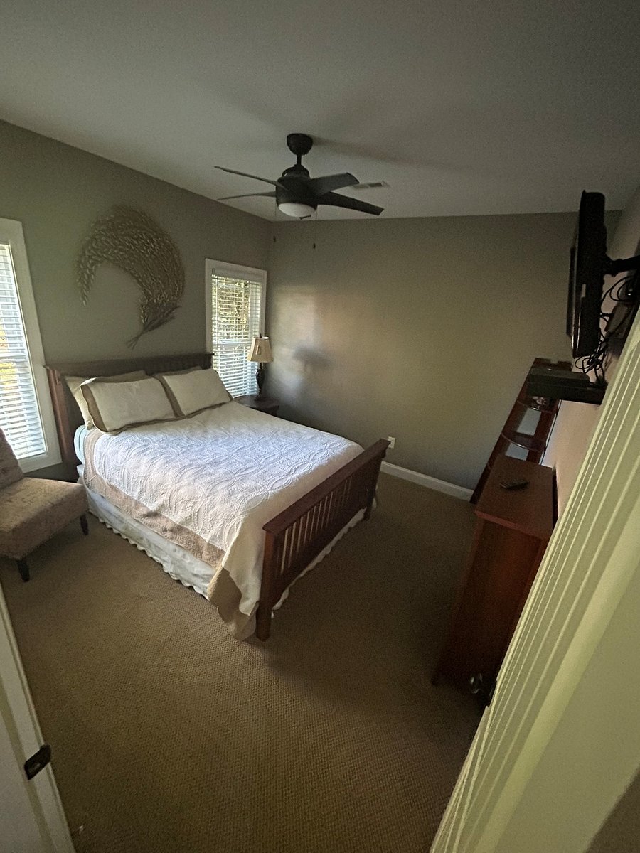 MOVE-IN READY BEDROOM: Your private queen bed and seating area. All high-quality linens and pillows are fully providedjust unpack your suitcase! Note: Includes a 32" Smart TV on a heavy-duty wall mount that can easily accommodate a larger screen if you prefer to bring your own.