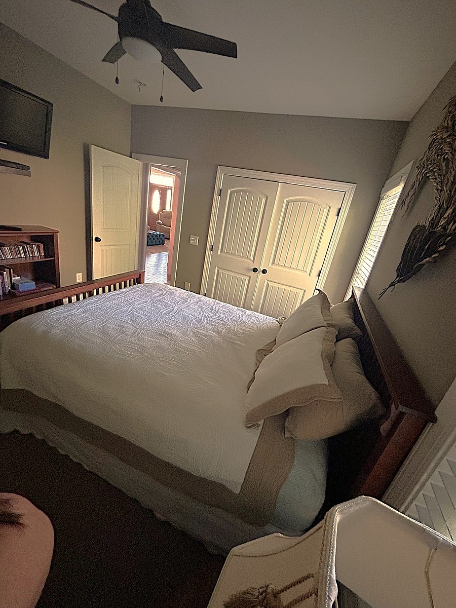 LAYOUT SEPARATION: View from your private bedroom threshold looking toward the central living space, demonstrating how your hallway wing remains separate from the rest of the home.