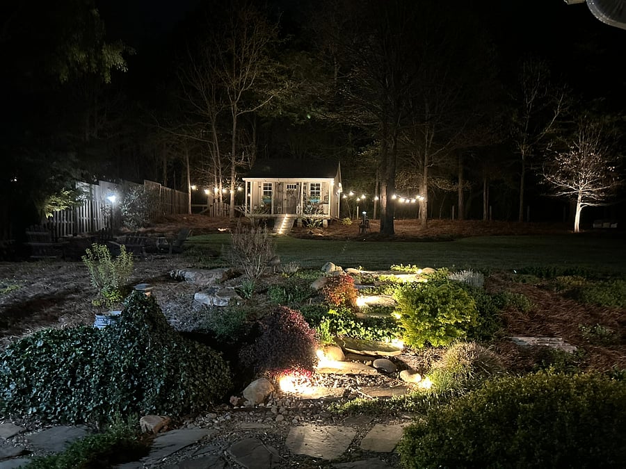 AMBIENT NIGHTTIME RETREAT: Unwind under the stars with landscape lighting and warm, glowing string lights. The backyard transforms into a peaceful, sanctuary perfect for relaxing after a long day or night shift.
