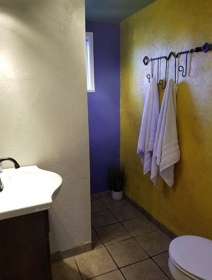 Small walk-in shower and hanging rack for towels