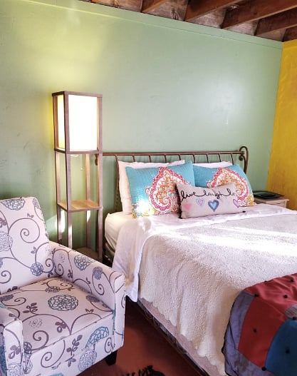 queen sized bed and sitting chair