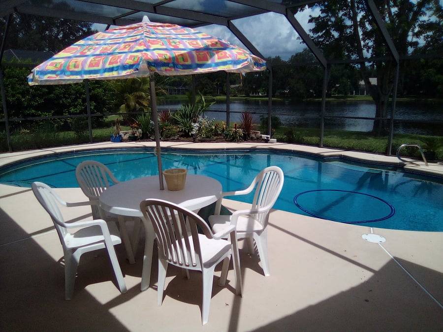 View of pool deck and pool as seen from the breakfast nook.