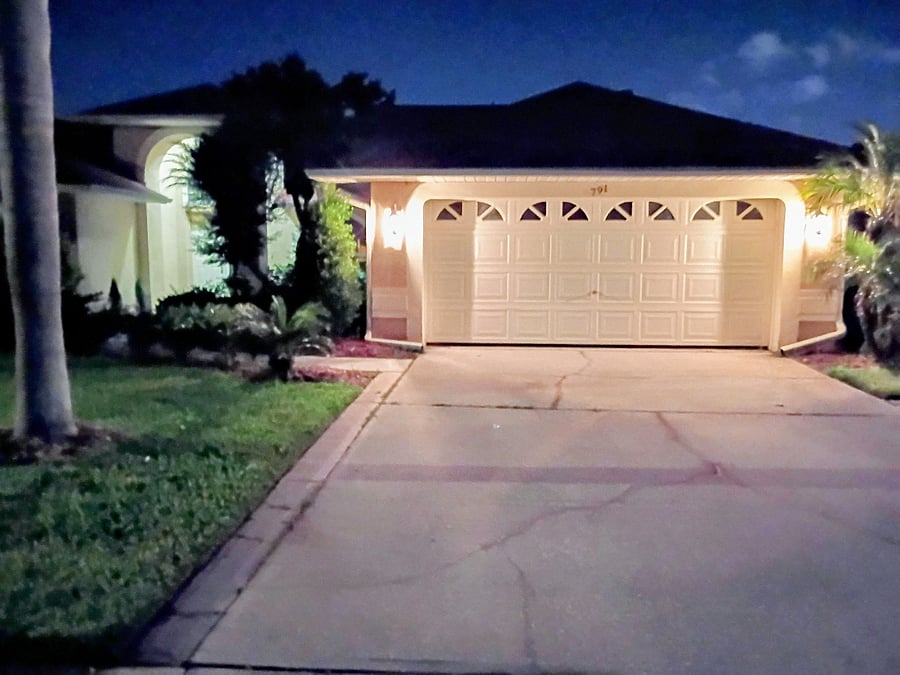 Night view of the front of the house showing easy, lighted access to the front door.
