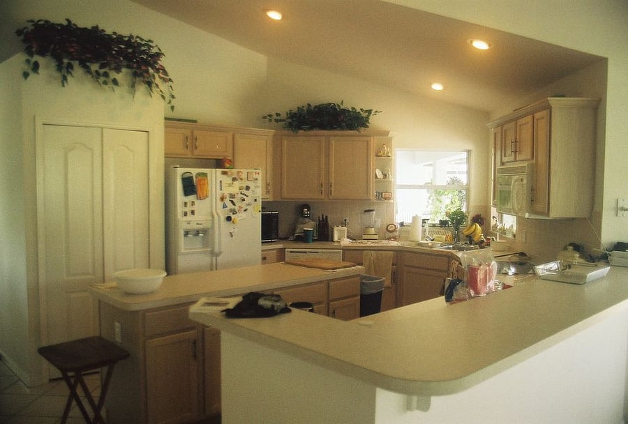 Wide view of the kitchen showing the refrigerator