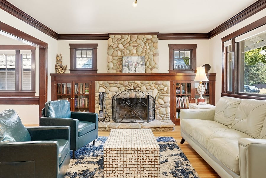 Living room with built in bookshelves and rock fireplace