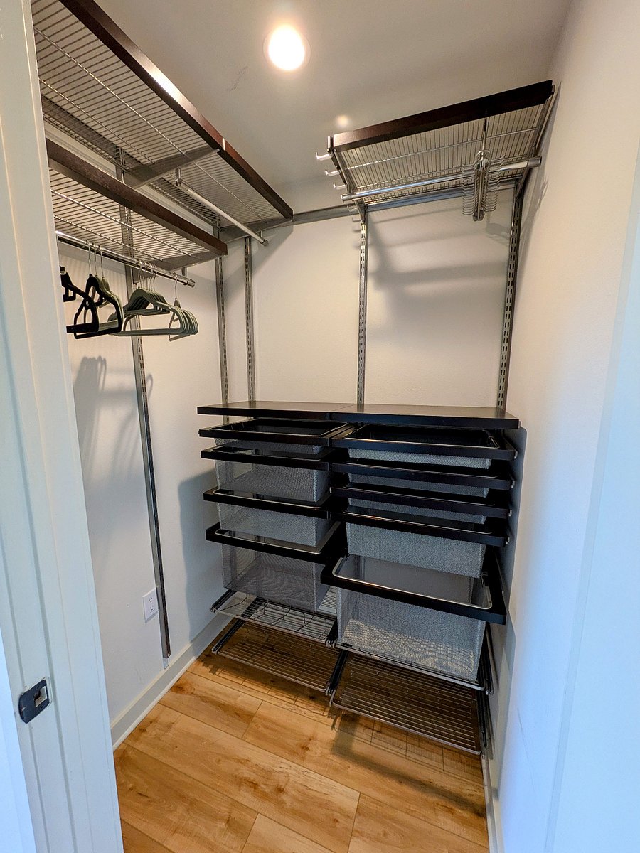 Elfa closet system with shoe racks and pull out drawers.