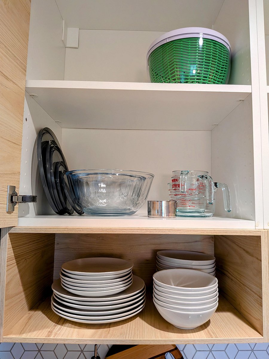 Mixing bowls and measuring cups, plus ample storage space in cabinets.