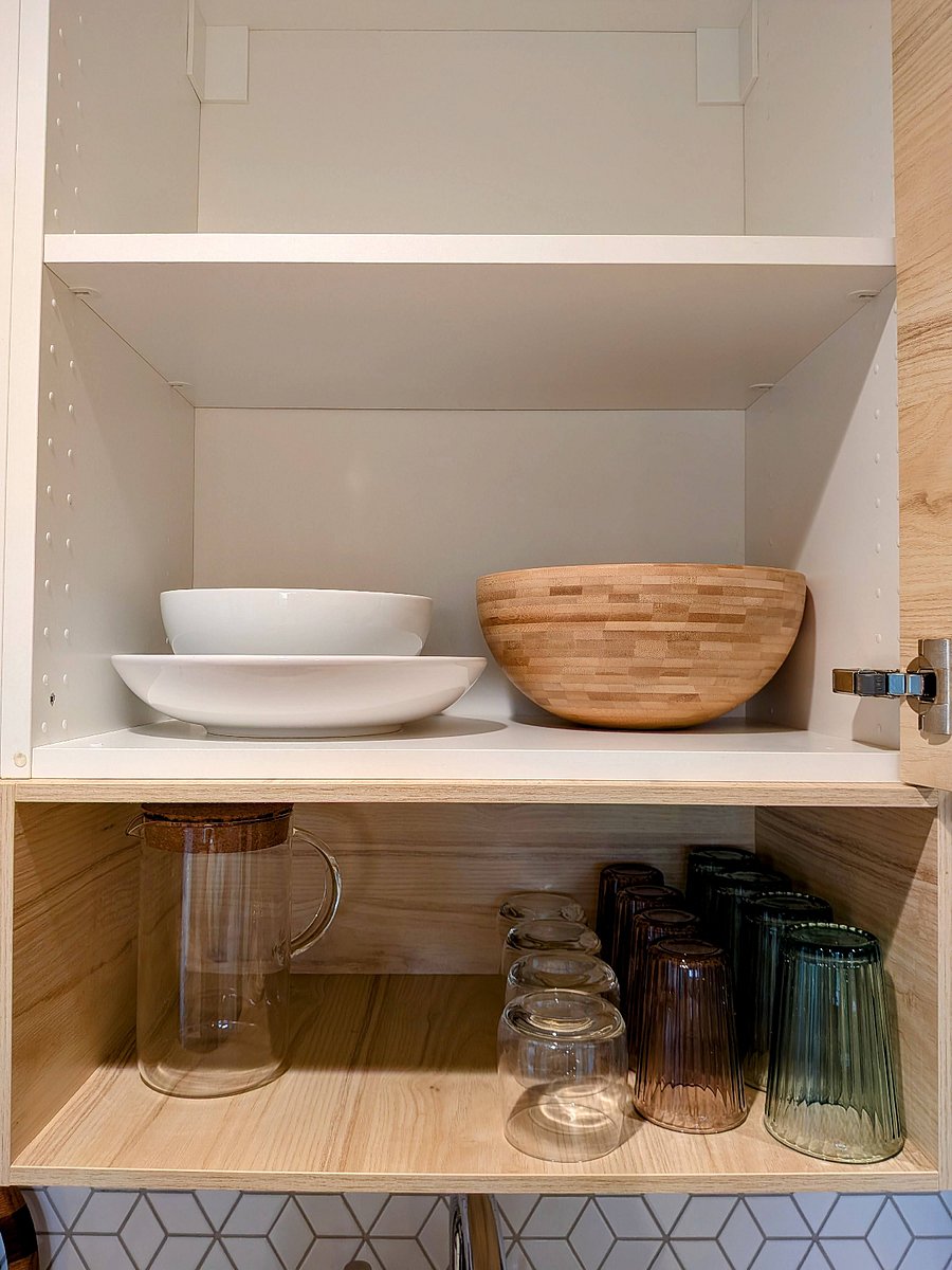 Serving platters and bowls, plus ample storage space in cabinets.