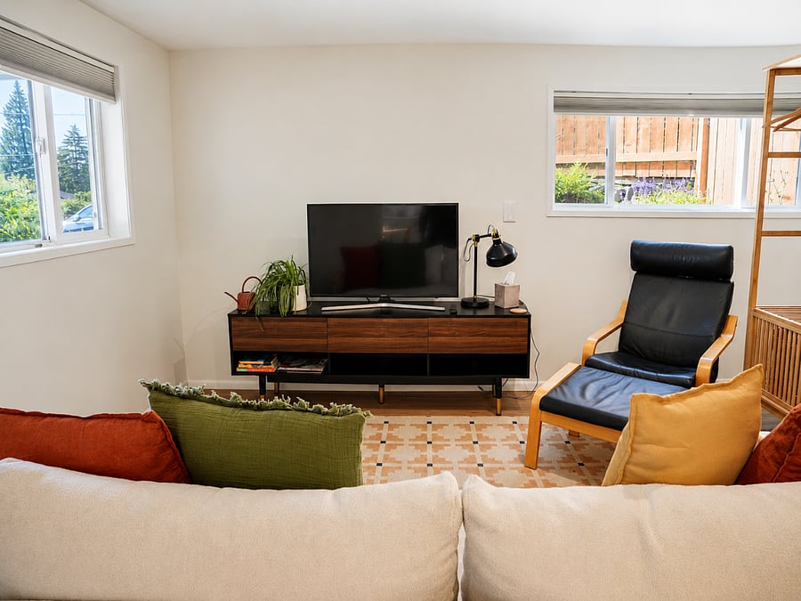 Cozy living area with smart TV and lounge seating.