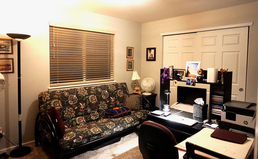 Guest Bedroom 2 with a futon that folds out into a double bed. Contains a workstation.