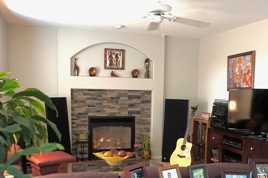 Living room with lighted fireplace and acoustic guitar