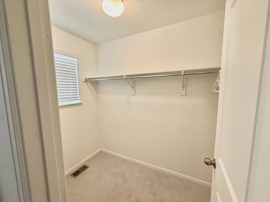 Secondary Bedroom (2): Large walk-in closet with hangers ready for your wardrobe.