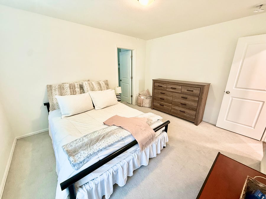 Secondary Bedroom (2): The large, second-floor secondary bedroom features a queen bedroom, full walk-in closet with hangers and full-sized dresser.