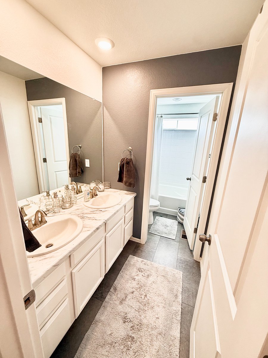 Secondary Bathroom: Premium linens supplied with a dual sink setup.