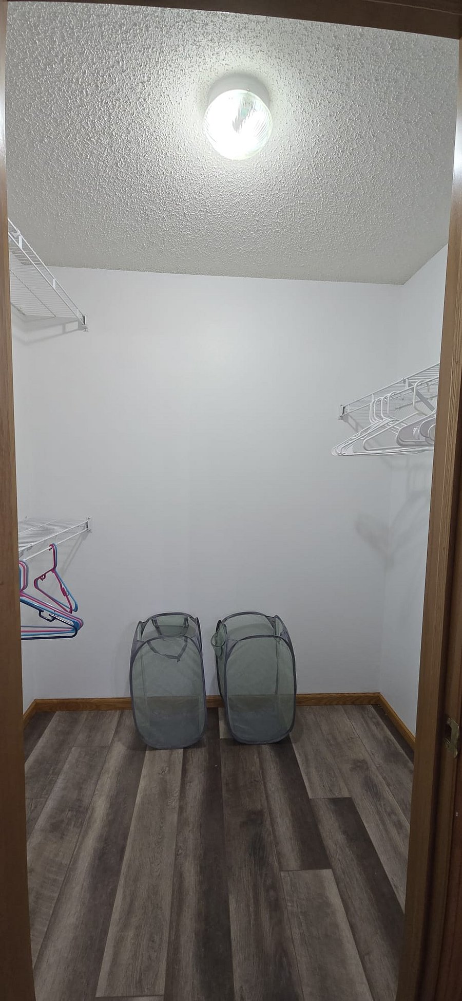 Walk in closet with 2 laundry hampers