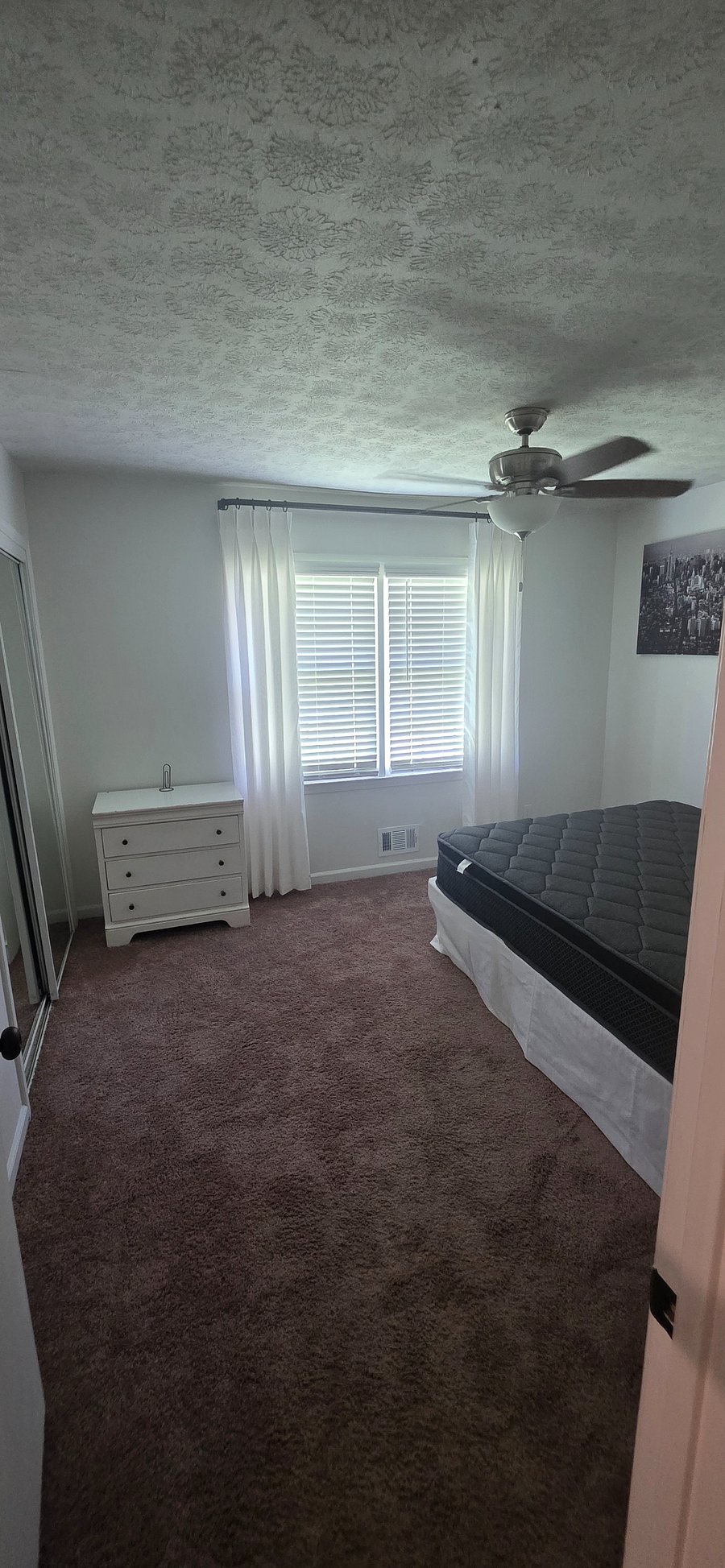 Bedroom 2, queen bed with sheets, curtains, sliding mirror door, 3 windows, pin board, small dresser, Small night stand with charger access 