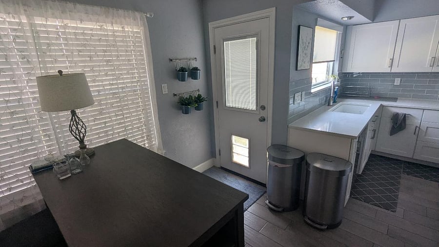 Large dog door installed in kitchen, with access to fully fenced backyard