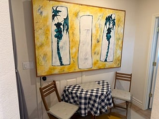 Kitchen table in hallway. Folds out for additional  seating