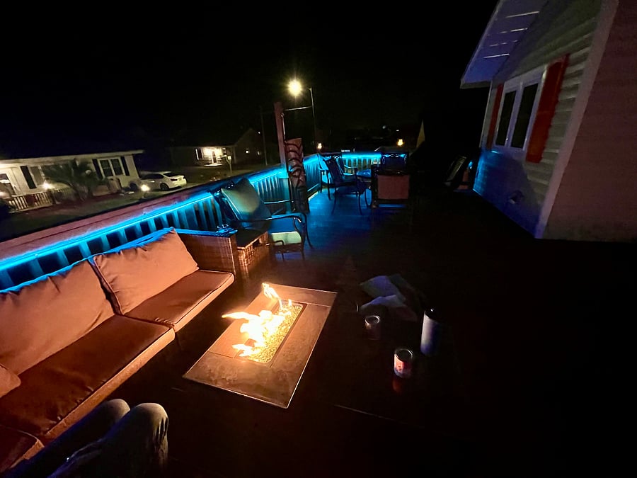 Upper deck at night with fire table and LED lights