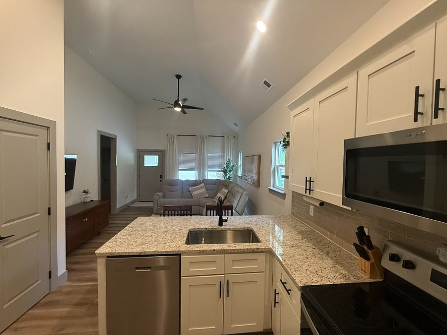 Kitchen has beautiful granite countertops and custom cabinets and a walk-in pantry. 