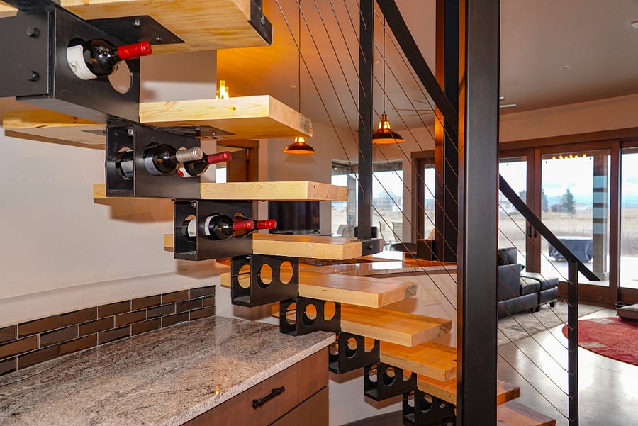 Staircase doubles as wine rack.